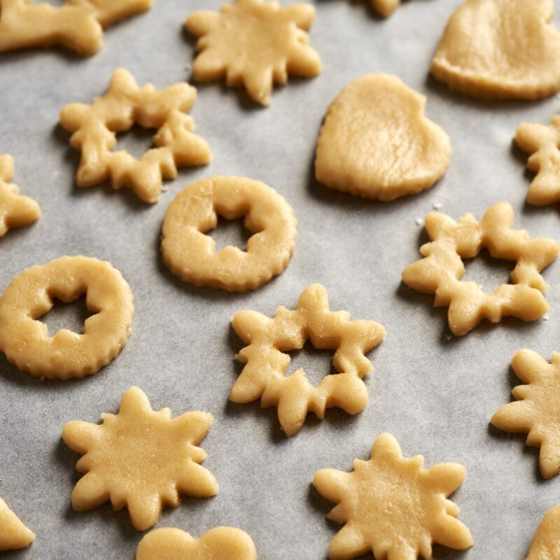 A selection of winter cookies on baking paper ready for the oven