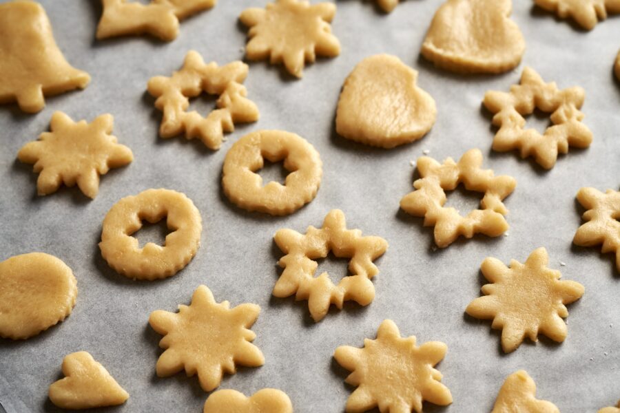 A selection of winter cookies on baking paper ready for the oven